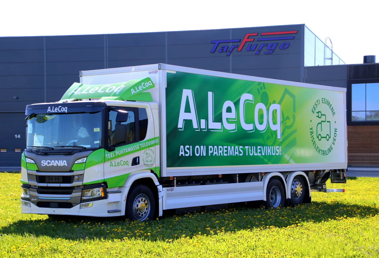 A. Le Coq branded green box truck promoting sustainable transport